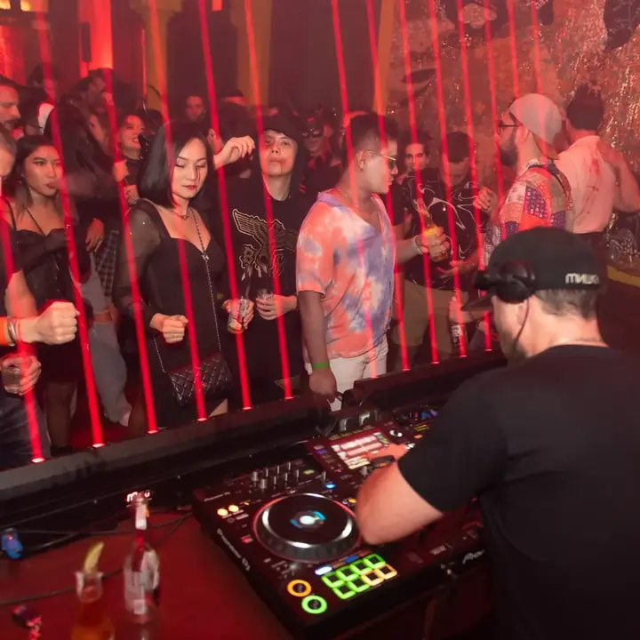 DJ and crowd behind red lasers at Halloween in Bangkok