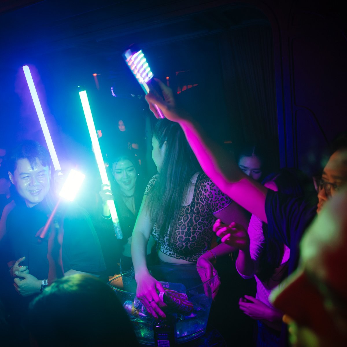Party crowd with light sticks at Mustache Bangkok