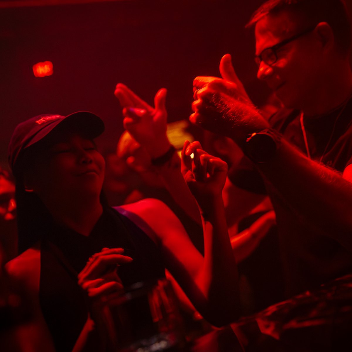 Dancefloor under red lights at Mustache Bangkok techno club