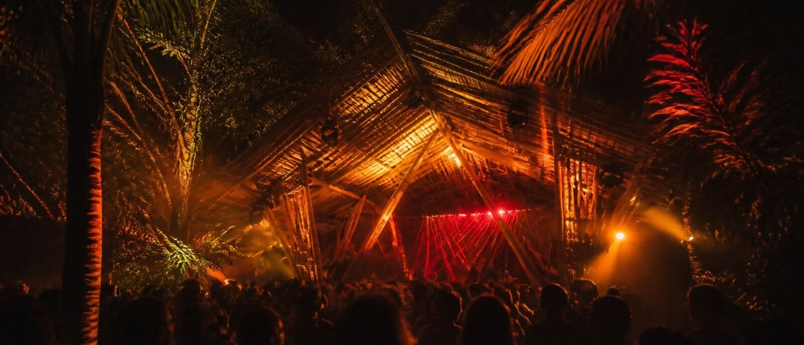 Techno stage made of bamboo in a tropical jungle at night