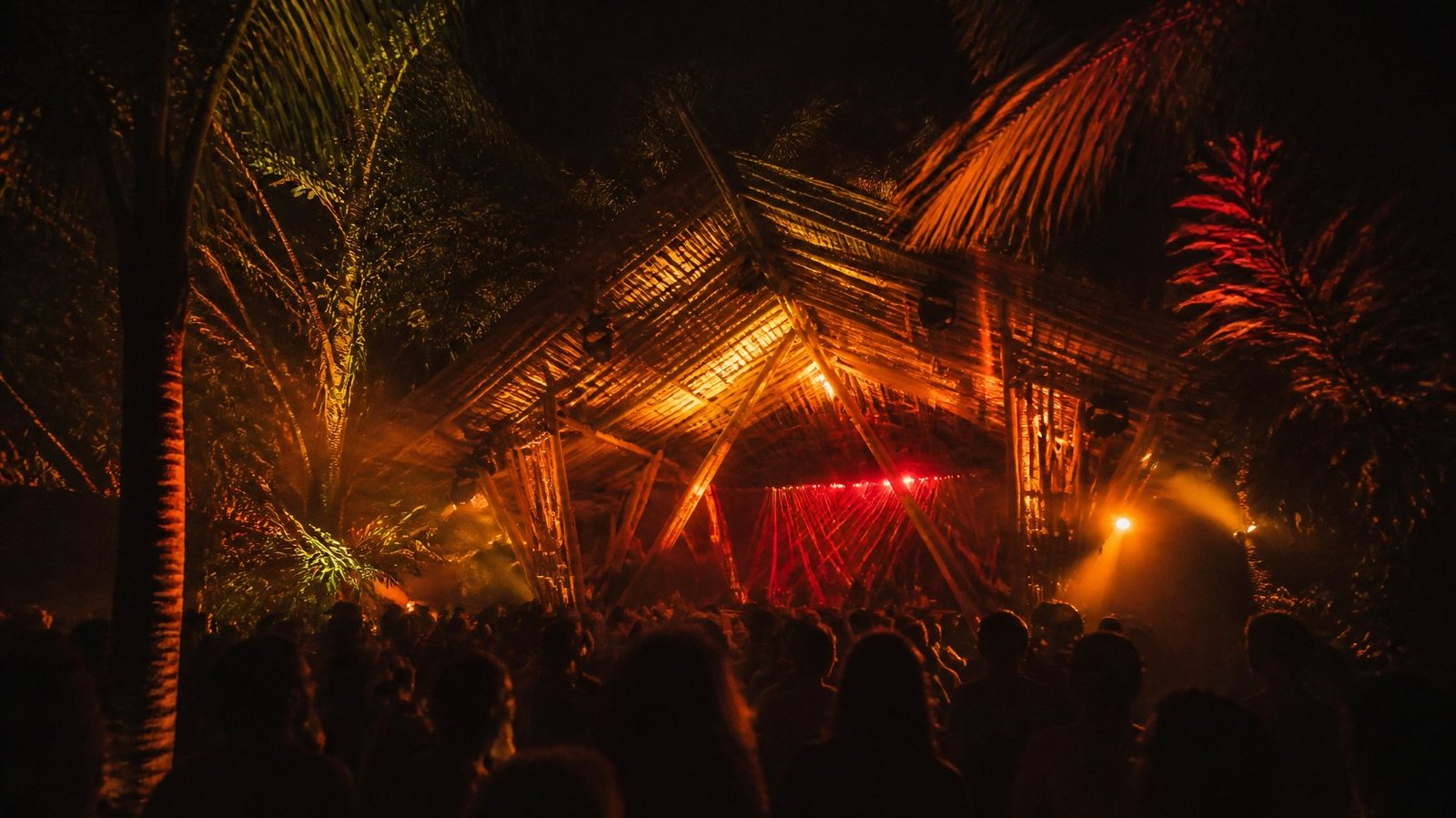 Techno stage made of bamboo in a tropical jungle at night
